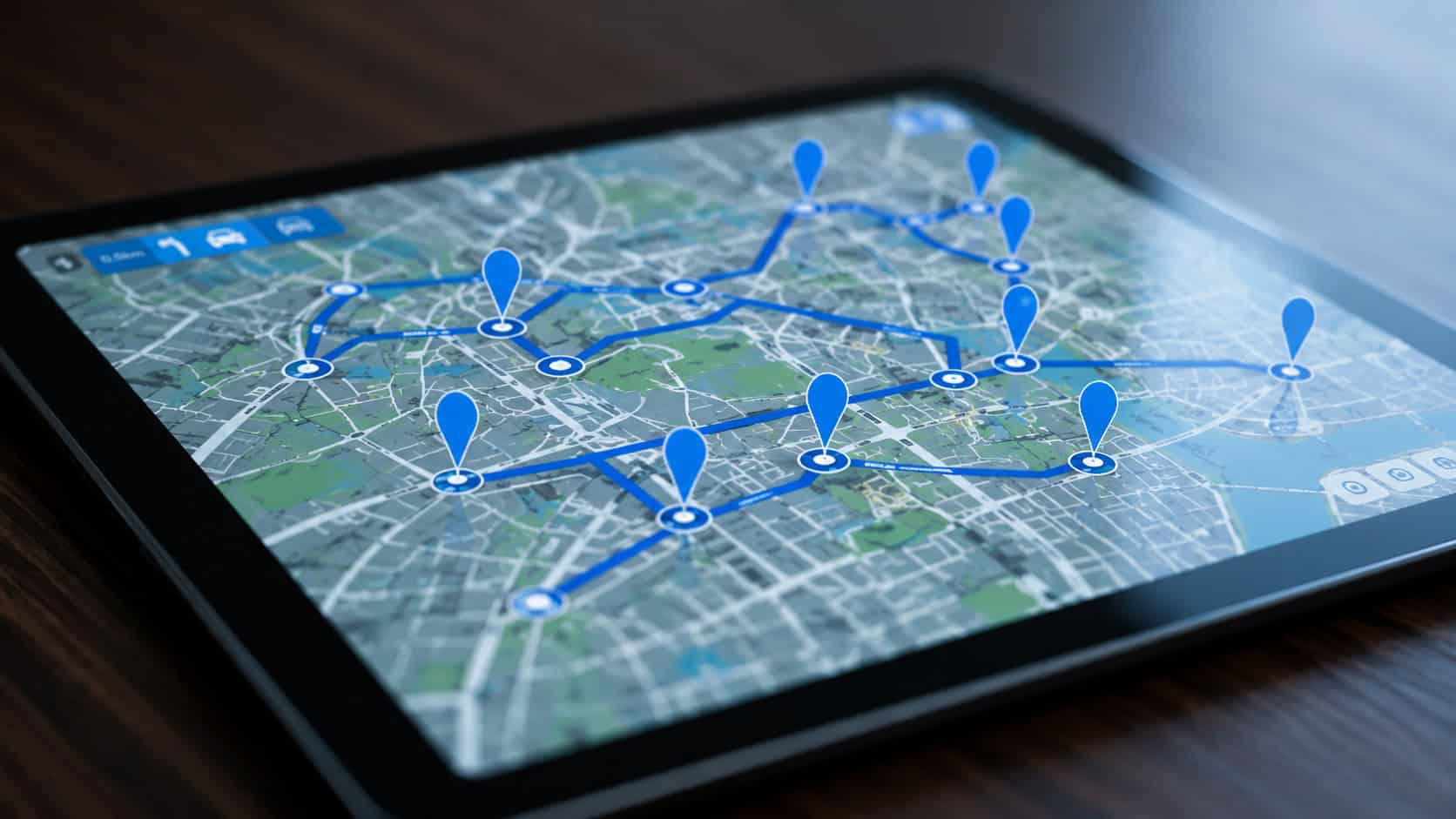 Tablet displaying a digital map with multiple connected location markers for asset tracking and fleet management.